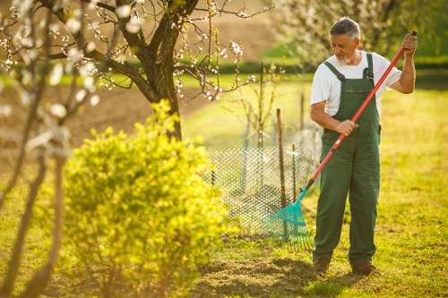 Garden clearance crew removing green waste in terrace garden